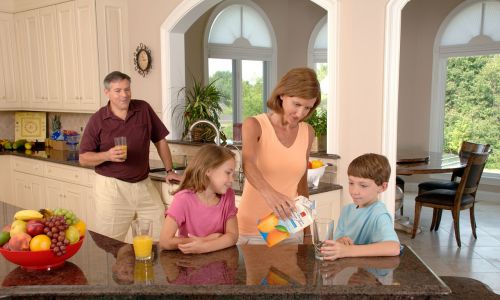 family drinking orange juice glass pouring
