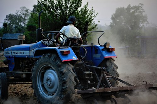 farmer  tractor  ploughing