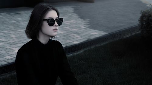 fashionable girl in glasses in the black