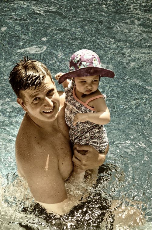 father swimming pool toddler
