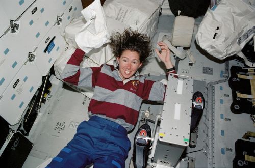 female astronaut washing hair space shuttle