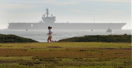female jogger aircraft carrier seaside