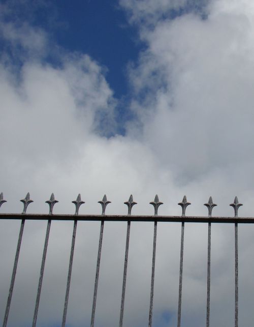 Fence Against Cloudy Sky