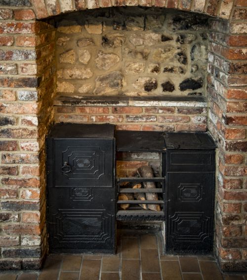Fireplace In A Brick Wall And Woods