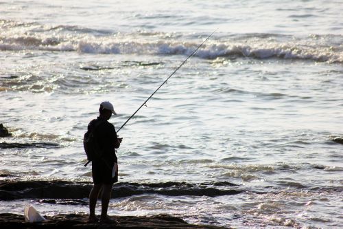 fisherman fishing waves