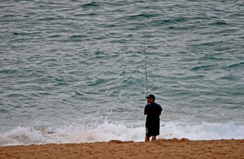 Fisherman On The Beach