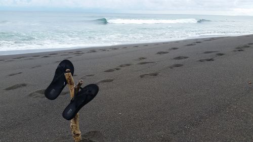 flip flops beach black sand