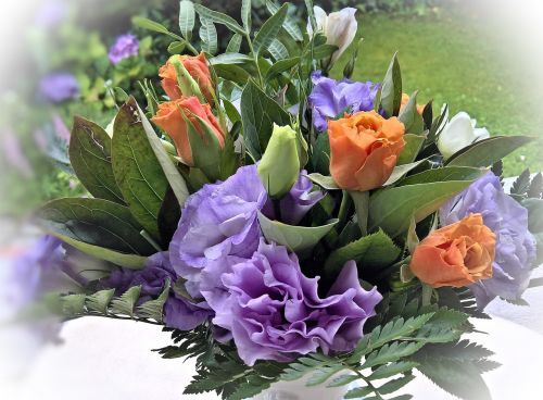 flower arrangement anemones in violet blue and white roses in orange