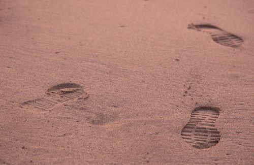 footprints leg sand