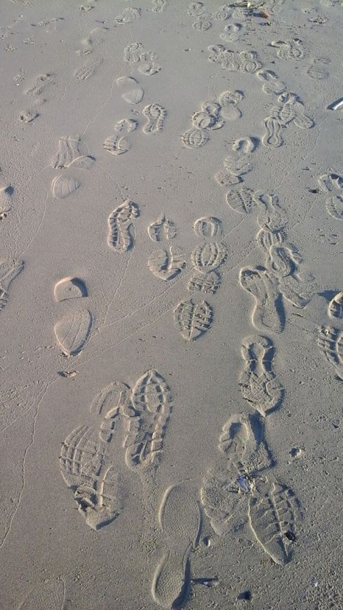 footprints sand busy