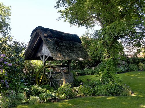 fountain thatched roof wagon wheel