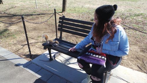 girl park bench squirrel