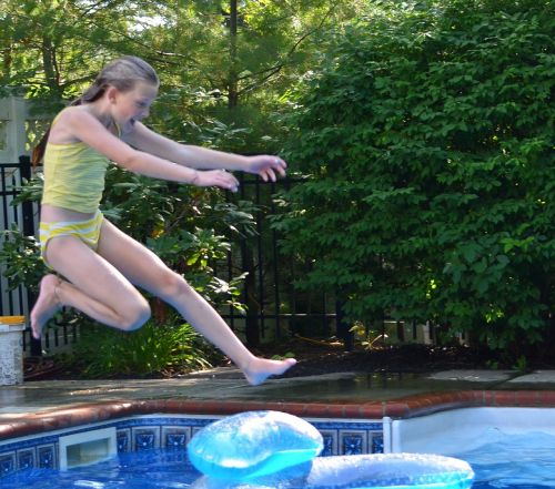 girl swimming pool jump