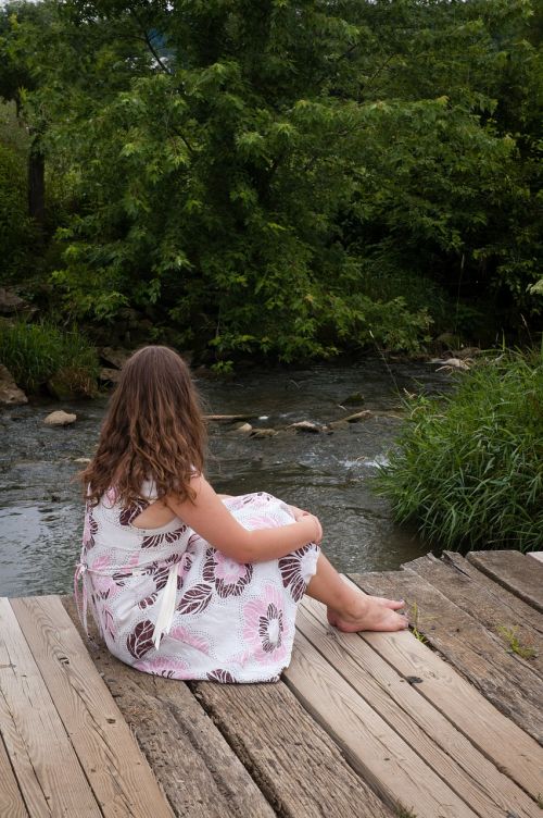 girl sitting bridge