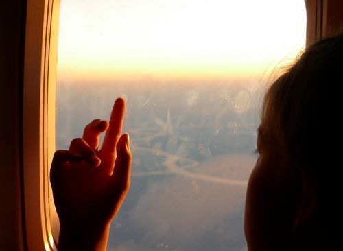 girl hand airplane window