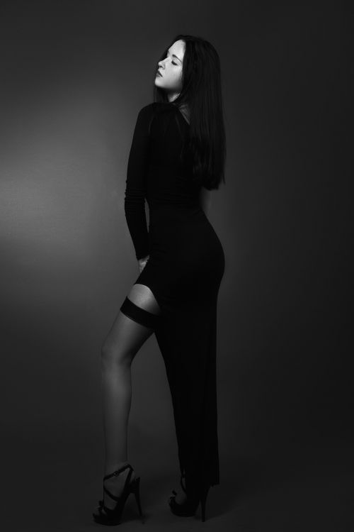 girl in a long in a black dress stockings