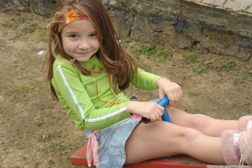 girl on a swing denim skirt a smile