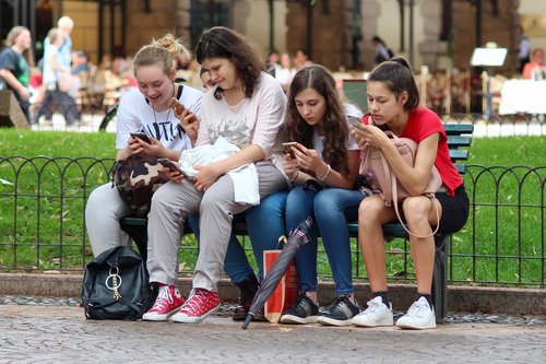 girls  cell phones  sitting