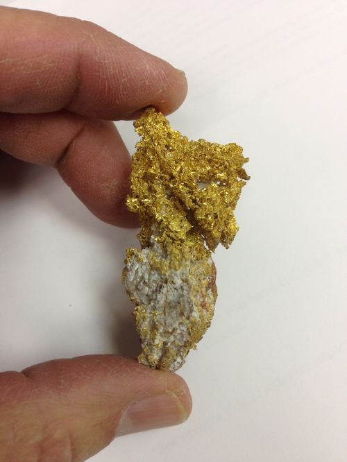 gold nugget holding gold hand