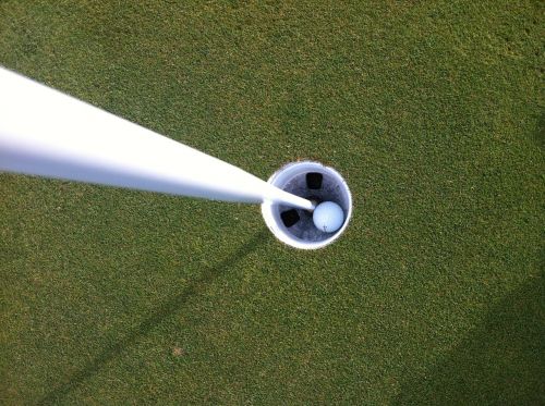golf ball in hole hole in one
