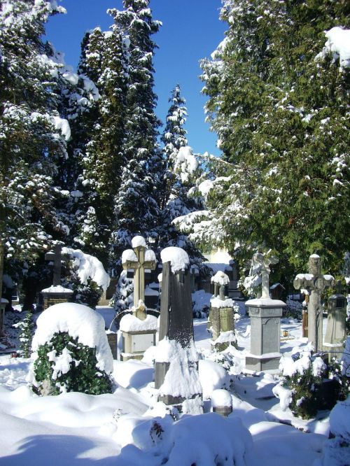 grave stones snow caps old cemetery