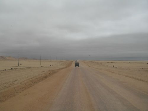 grey sky salt road lone vehicle