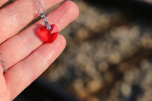 hand  red heart medallion  love symbol