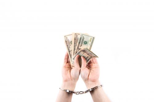 Hands In Handcuffs Hold Money