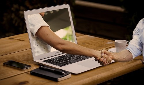 handshake  hands  laptop
