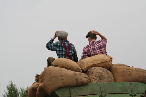 boys sitting on grain bags