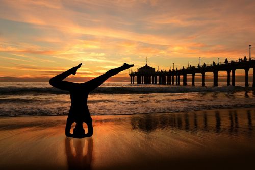 headstand yoga on the beach sunset beach
