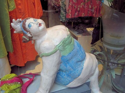 heavy lady clay sculpture shop window