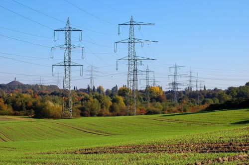high-voltage pylons power poles field