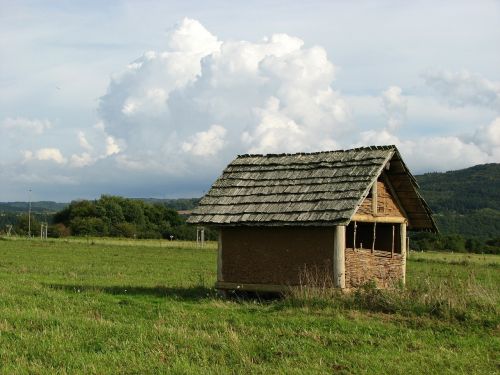 hut pasture clouds