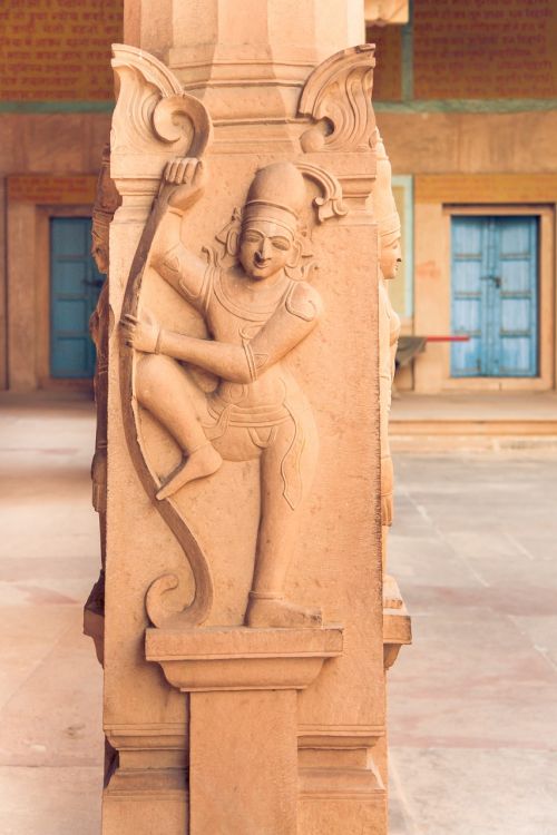 indian statue on the column vrindavan rock