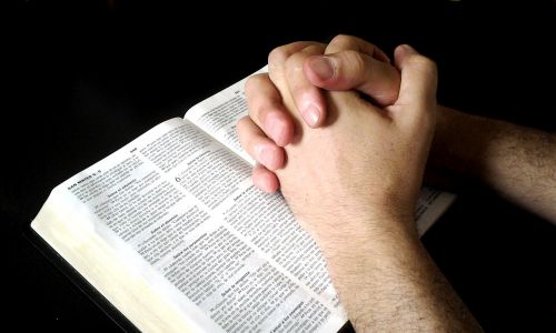 interlocking hands prayer bible