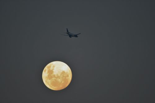 Jet Aircraft Passing Moon