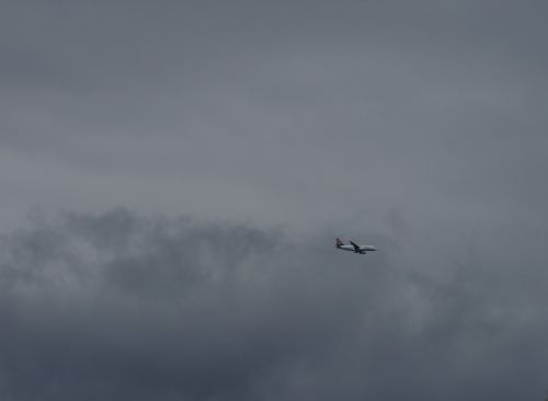 Jet In Clouded Sky