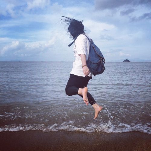 jumping beach blue sky