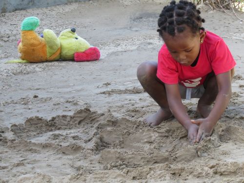 kid playing beach