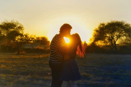 kissing couple romance sunset