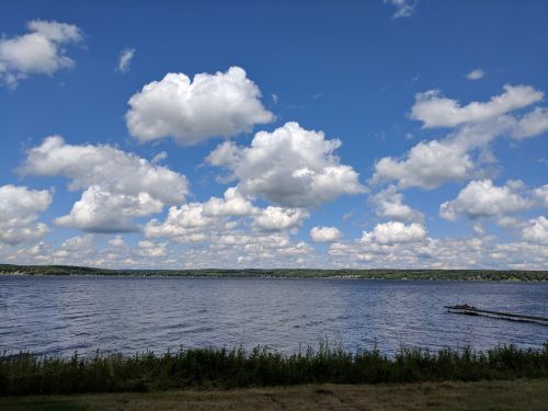 lake chautauqua fluffy clouds blue sky over water