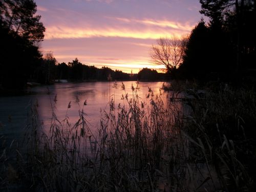 lake in winter sunrise ice cover