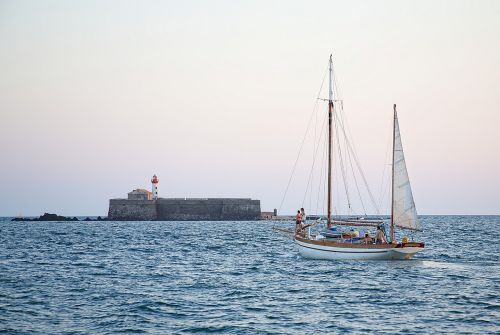 lighthouse sailboat sea