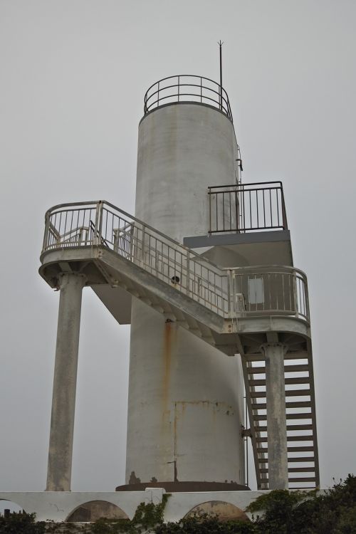 lighthouse coast partly cloudy