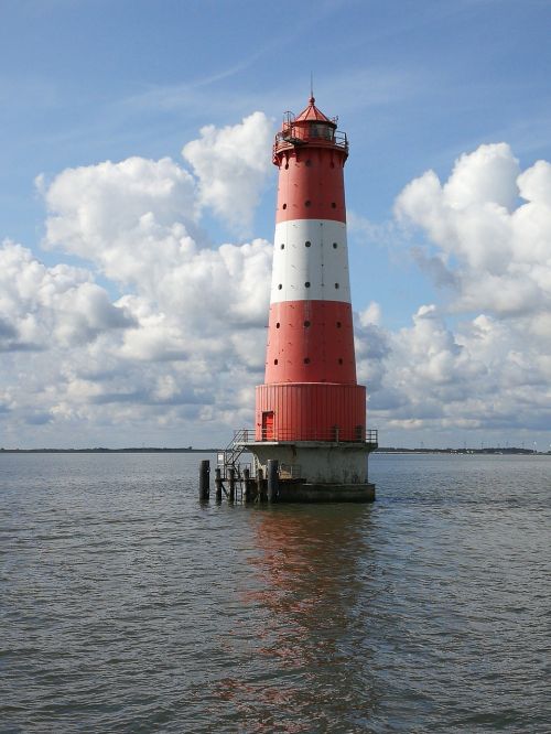 lighthouse clouds sea