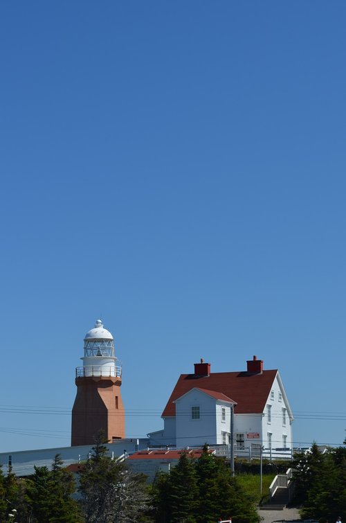 lighthouse  old farmhouse  blue sky