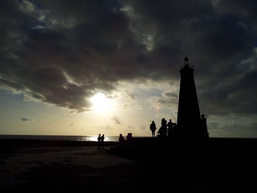 lighthouse silhouettes sunset