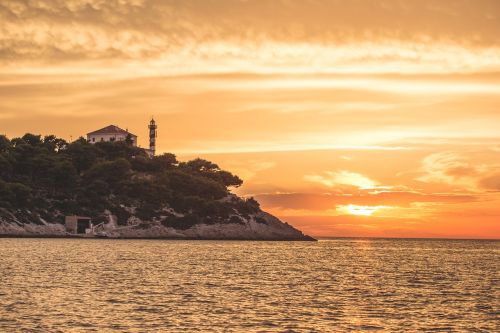 lighthouse sunset sea