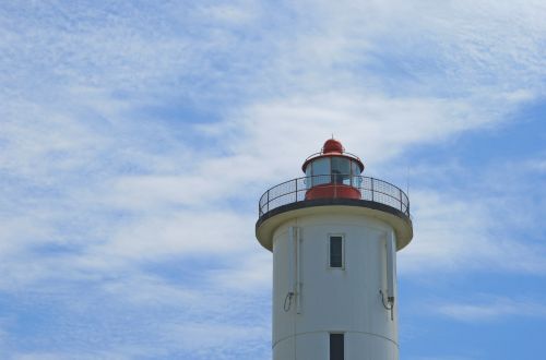 Lighthouse Against Wispy Clouds